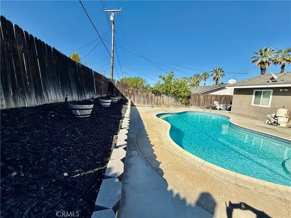 a view of a swimming pool with a yard
