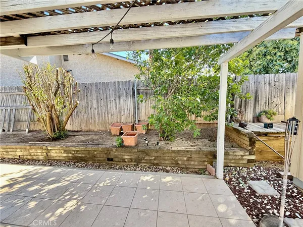 a view of a backyard with table and chairs and potted plants