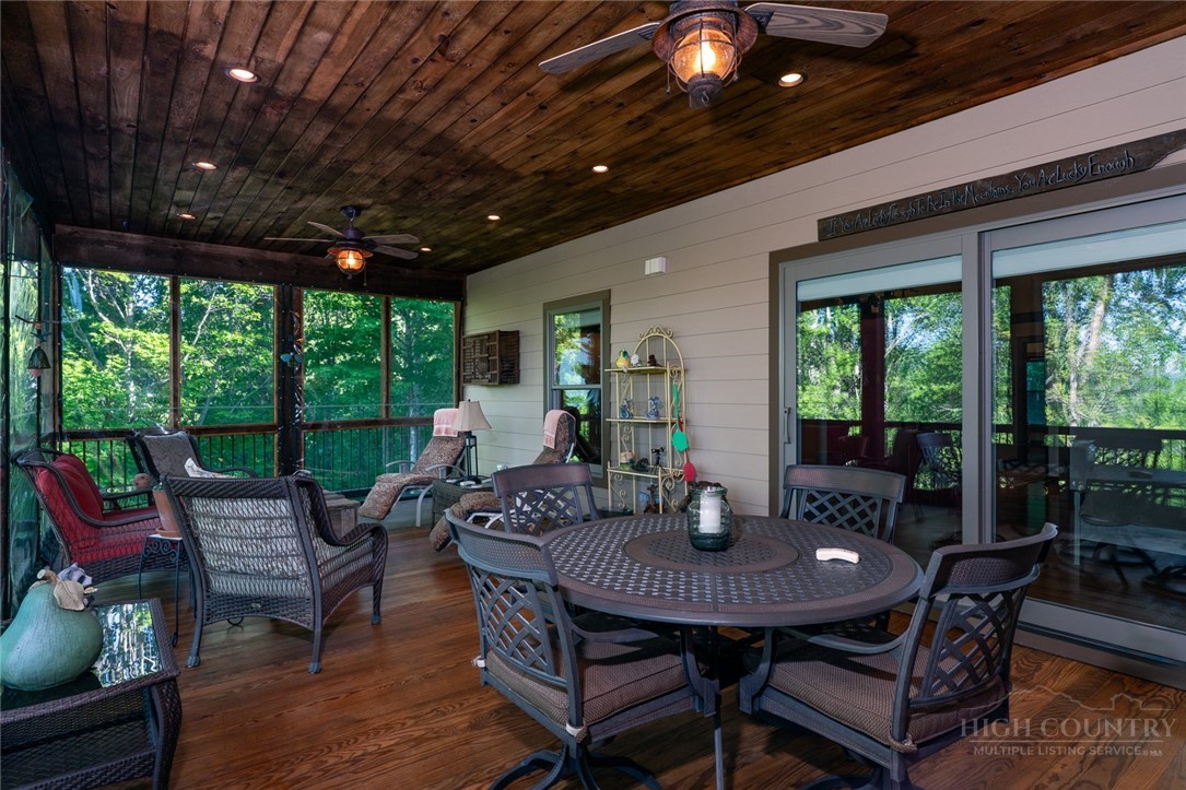 171 Camp Davis Road Banner Elk, NC 28604 - Photo 8 of 48 a view of a patio with a table chairs and a backyard