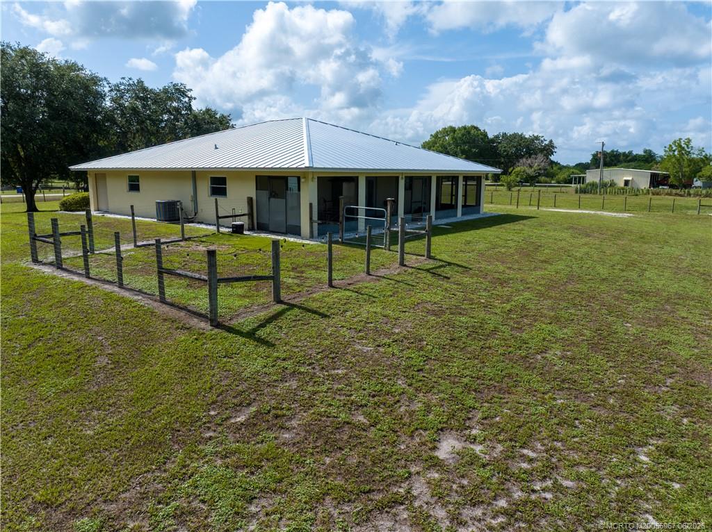 8200 Southwest Springhaven Avenue Indiantown, FL 34956 - Photo 34 of 35 a front view of a house with a garden