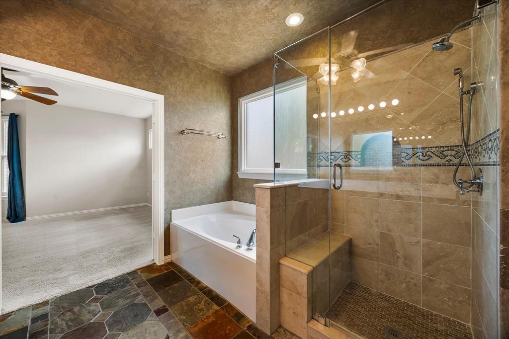 645 Channel Ridge Drive Rockwall, TX 75087 - Photo 20 of 40 The shower features a frameless glass enclosure and handy bench.