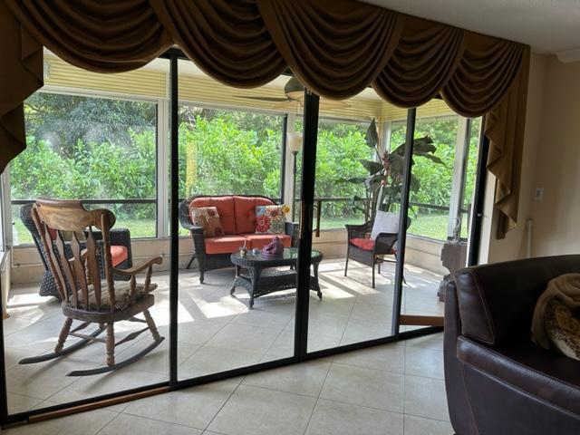 336 Northwest 42nd Street Boca Raton, FL 33431 - Photo 11 of 13 living out to screened patio