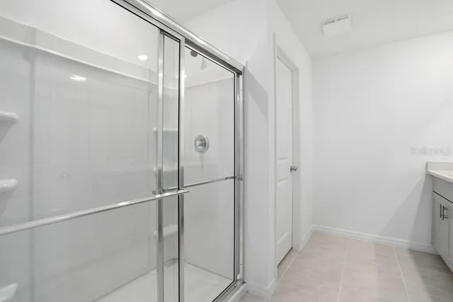 a bathroom with a glass shower door