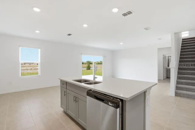 a kitchen that has a sink and a stove in it