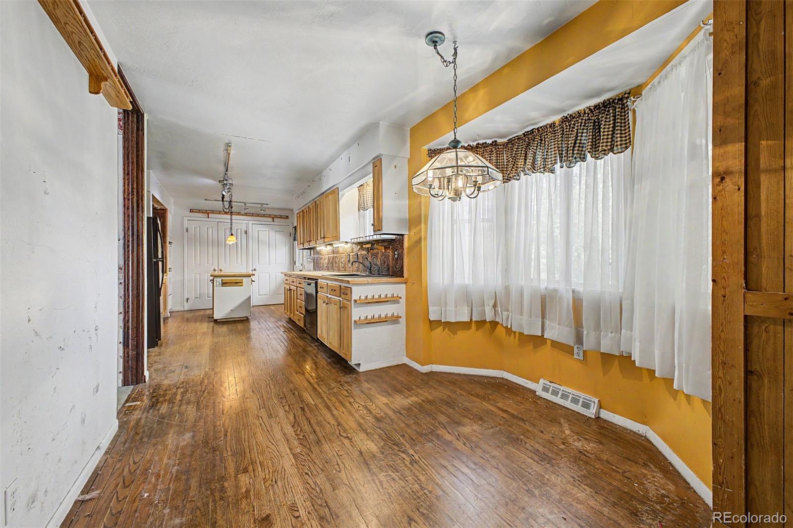 1600 Northwestern Road Longmont, CO 80503 - Photo 13 of 41 a view of a kitchen with wooden floor electronic appliances and furniture