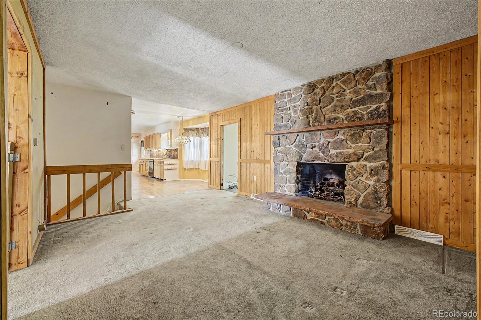 1600 Northwestern Road Longmont, CO 80503 - Photo 14 of 41 an empty room with fireplace and a window