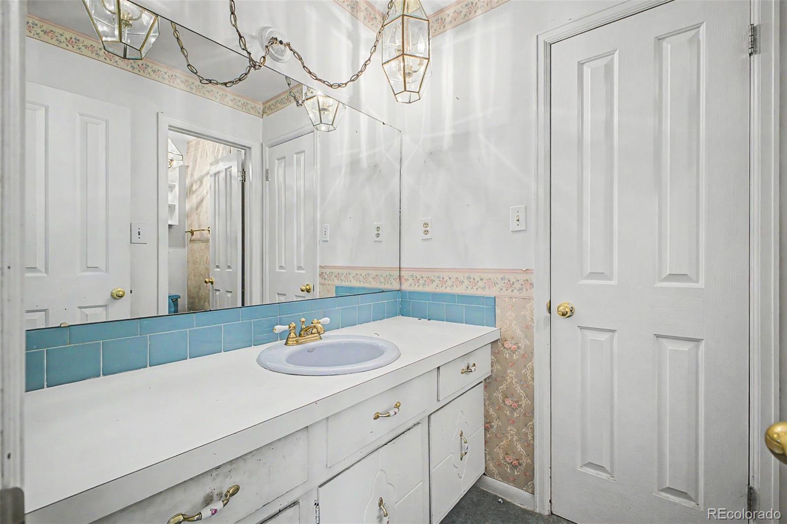 1600 Northwestern Road Longmont, CO 80503 - Photo 22 of 41 a bathroom with a sink a vanity and a mirror