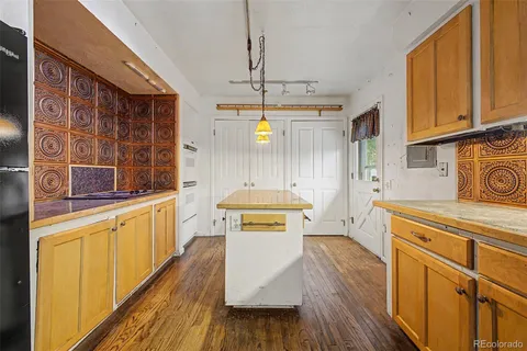 a kitchen with stainless steel appliances a stove a sink dishwasher and cabinets with wooden floor