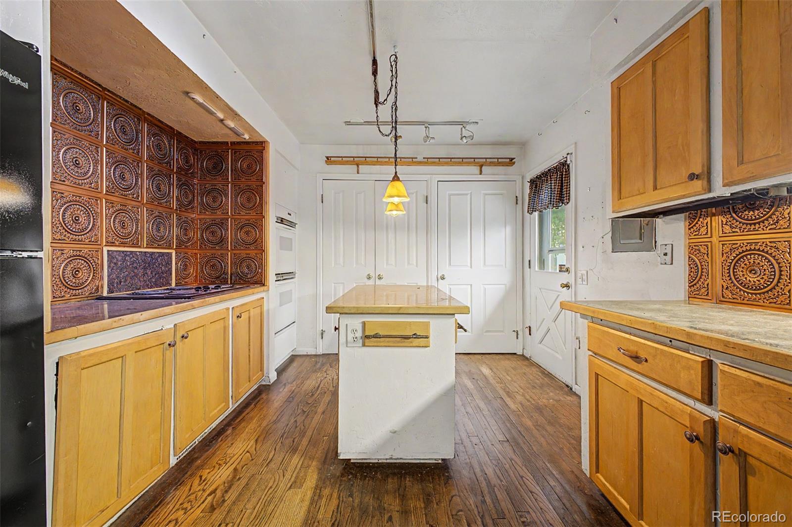 1600 Northwestern Road Longmont, CO 80503 - Photo 9 of 41 a kitchen with stainless steel appliances a stove a sink dishwasher and cabinets with wooden floor
