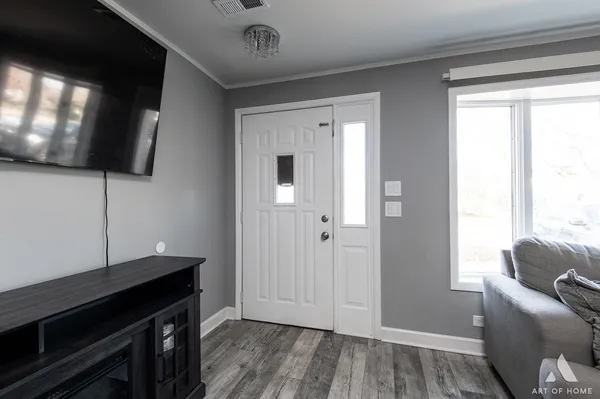 a living room with a flat screen tv and a window