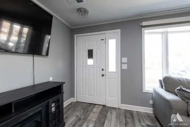a living room with a flat screen tv and a window