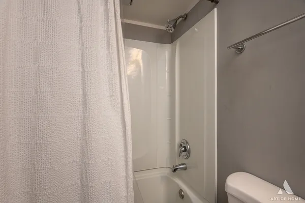 a bathroom with a shower and a toilet