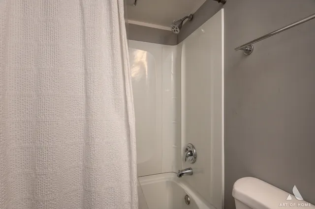 a bathroom with a shower and a toilet