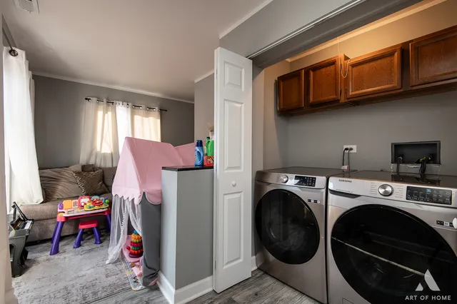 a utility room with sink dryer and washer
