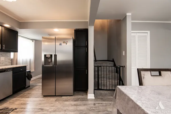 a kitchen with stainless steel appliances granite countertop a refrigerator and a sink