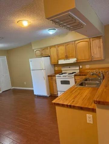 a kitchen with a sink and a refrigerator