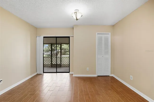 a view of an empty room with glass door