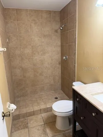 a bathroom with a toilet a sink and shower