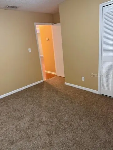 an empty room with closet area
