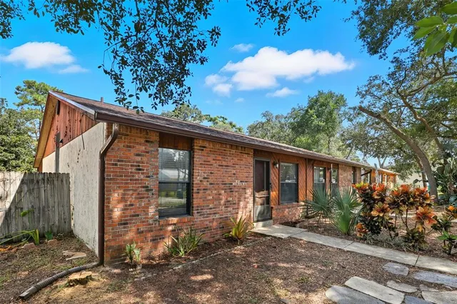 a view of a house with a tree in the background