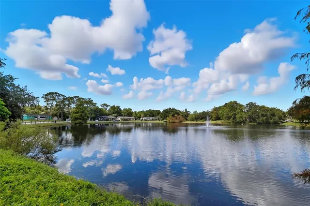 a view of a lake with houses in the back