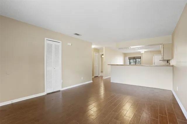 a view of a kitchen with wooden floor and a sink