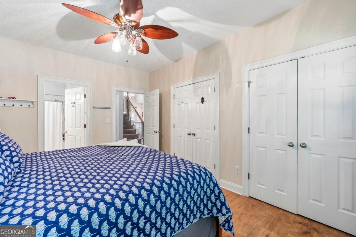 172 Mays Road Milledgeville, GA 31061 - Photo 25 of 54 a bedroom with a bed and a chandelier