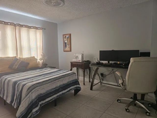a bedroom with a bed and a desk