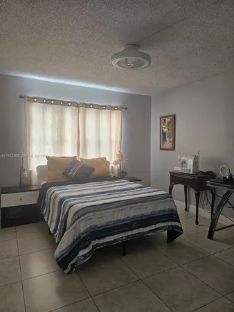 a spacious bedroom with a bed and a table in it