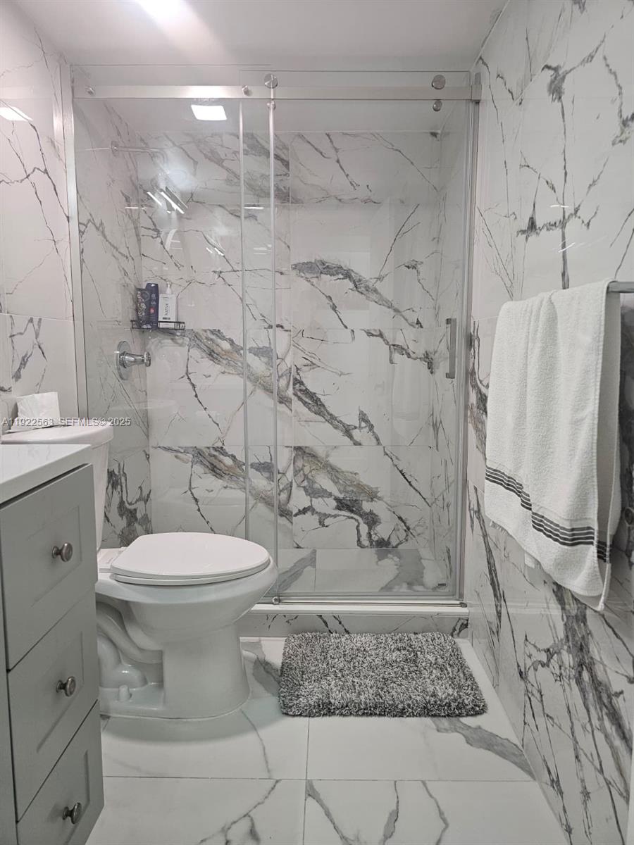 8411 Northwest 8th Street, Unit 111 Miami, FL 33126 - Photo 24 of 27 a bathroom with a toilet and a shower