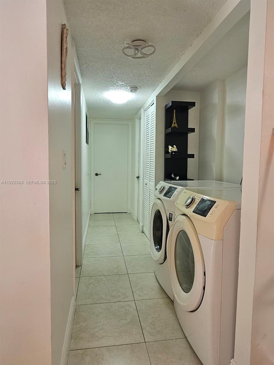 8411 Northwest 8th Street, Unit 111 Miami, FL 33126 - Photo 25 of 27 a view of a storage & utility room with washer and dryer