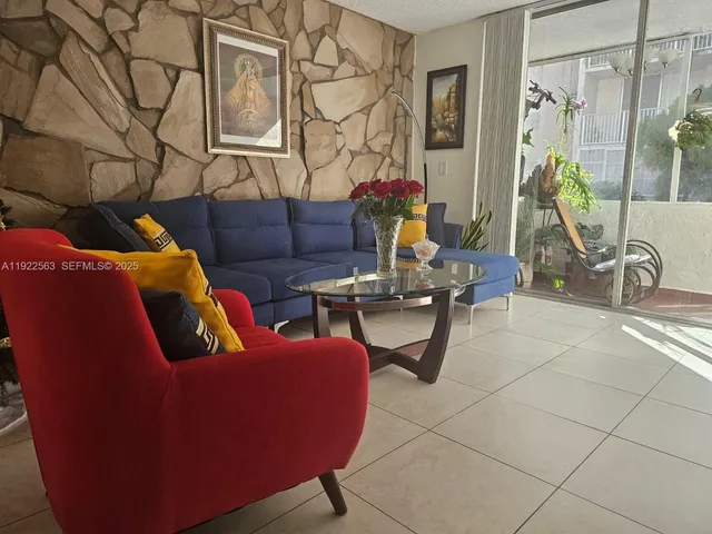 a living room with furniture a rug and white walls