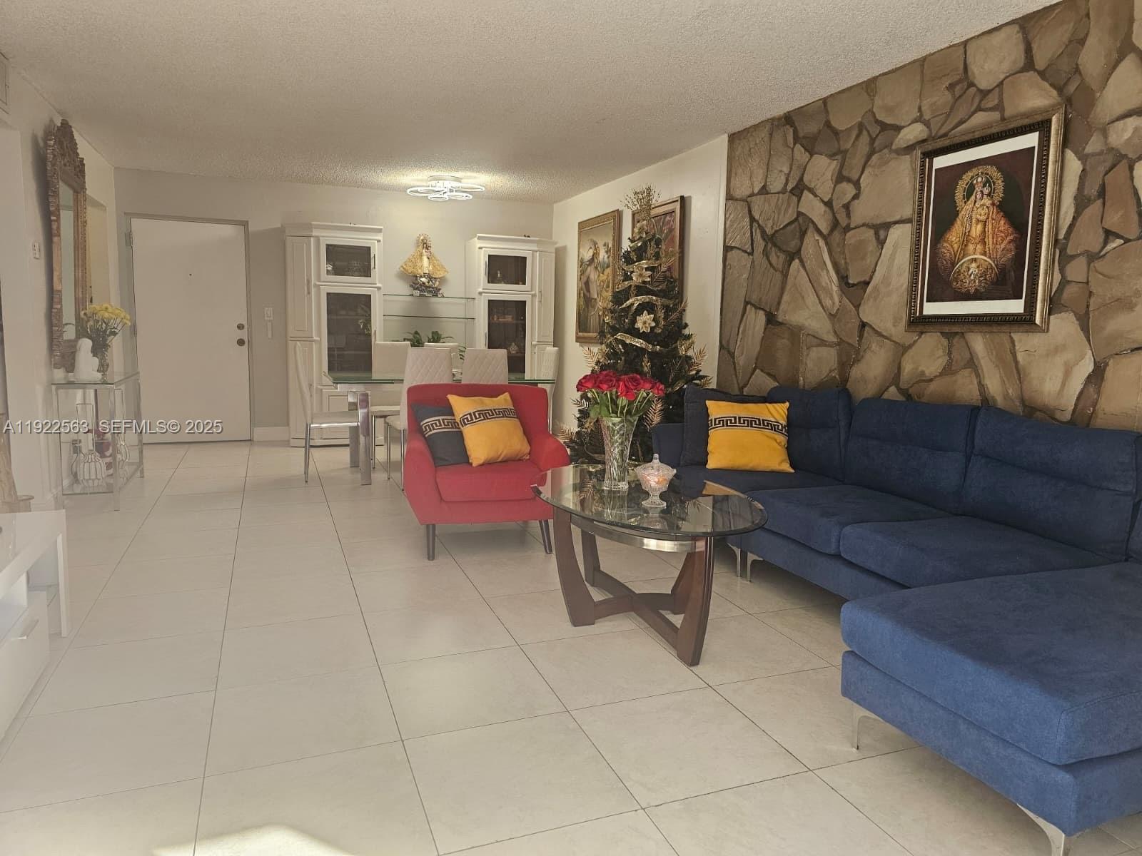 8411 Northwest 8th Street, Unit 111 Miami, FL 33126 - Photo 6 of 27 a living room with furniture and a potted plant