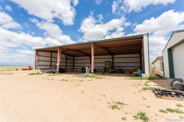 a view of a patio with table and chairs under an umbrella