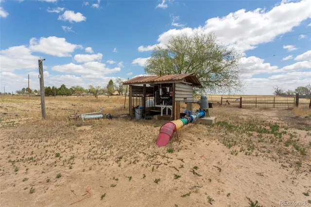 a view of a backyard of a house with wooden fence