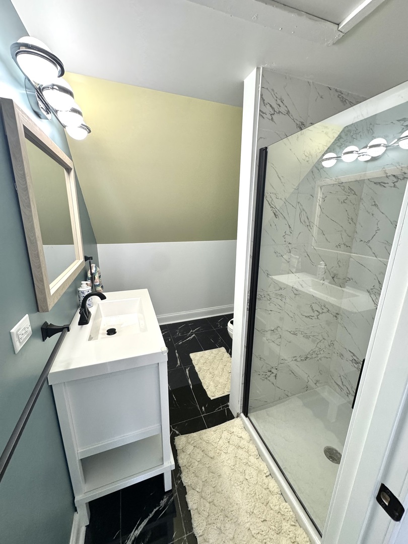 931 South Rawson Bridge Road Cary, IL 60013 - Photo 19 of 36 a bathroom with a sink toilet and shower