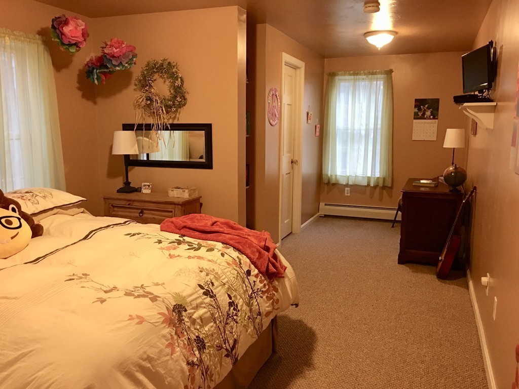41 Prescott Street Rutland, MA 01543 - Photo 28 of 30 a bedroom with a bed and wooden floor
