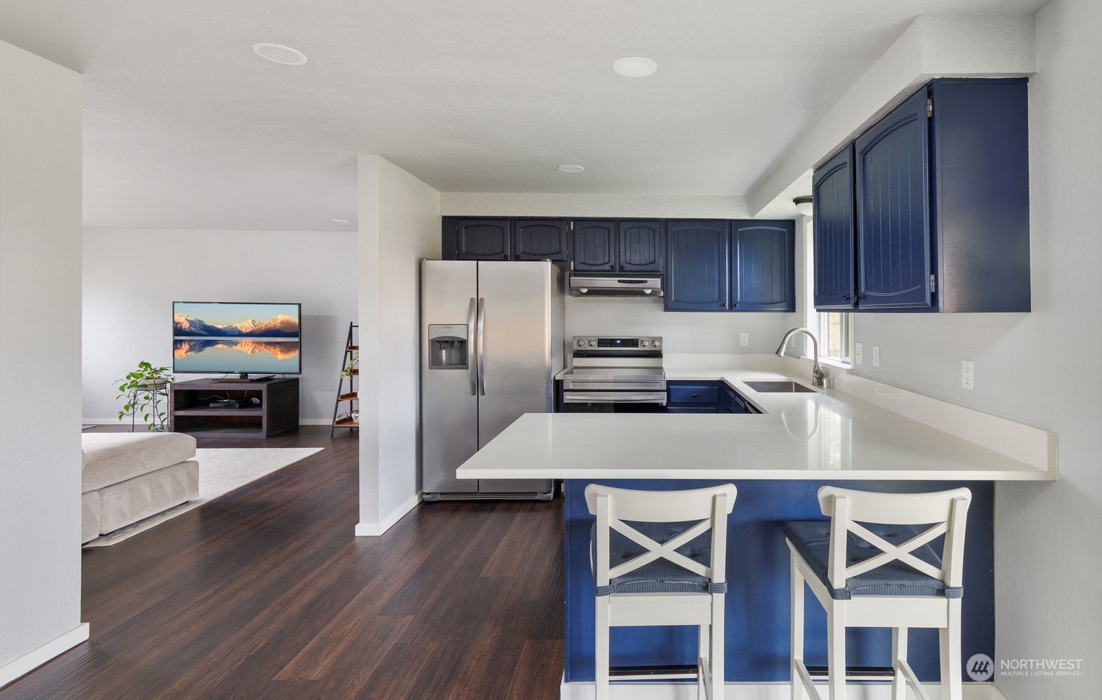827 Natalie Place Enumclaw, WA 98022 - Photo 5 of 18 a kitchen with a wooden table chairs refrigerator and cabinets