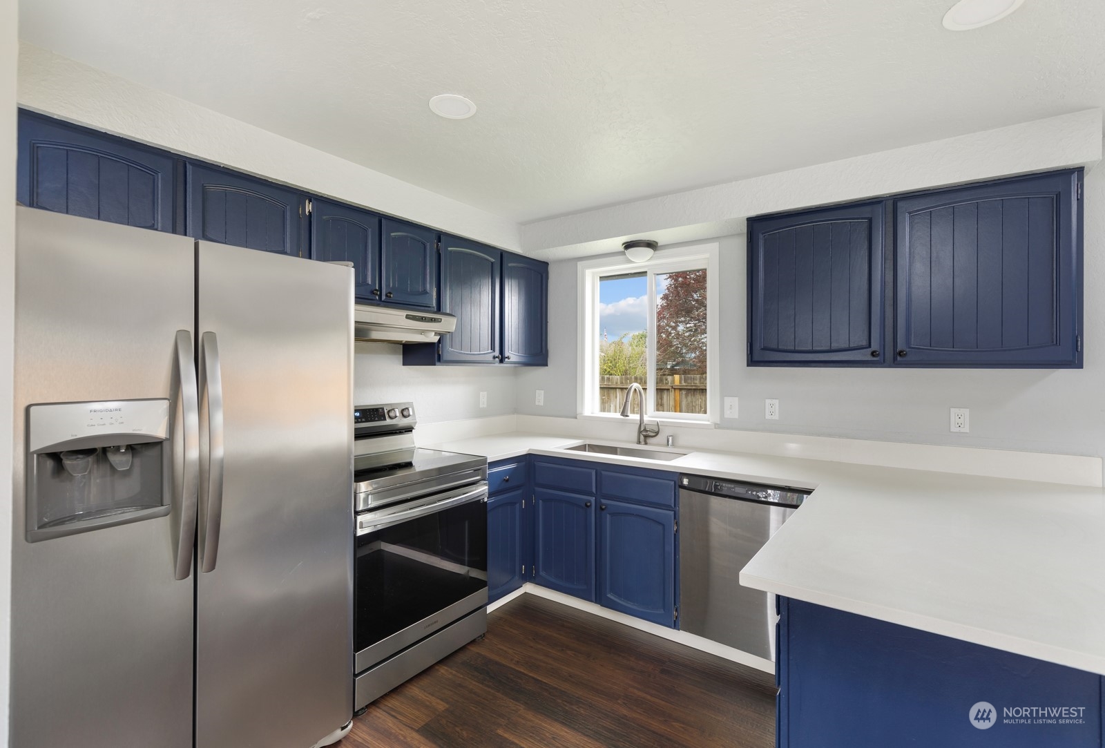 827 Natalie Place Enumclaw, WA 98022 - Photo 6 of 18 a kitchen with a sink stainless steel appliances and cabinets