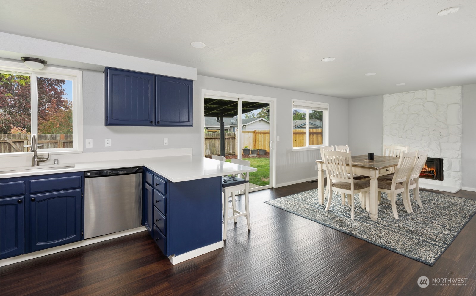 827 Natalie Place Enumclaw, WA 98022 - Photo 7 of 18 a kitchen with granite countertop a dining table chairs and wooden floor