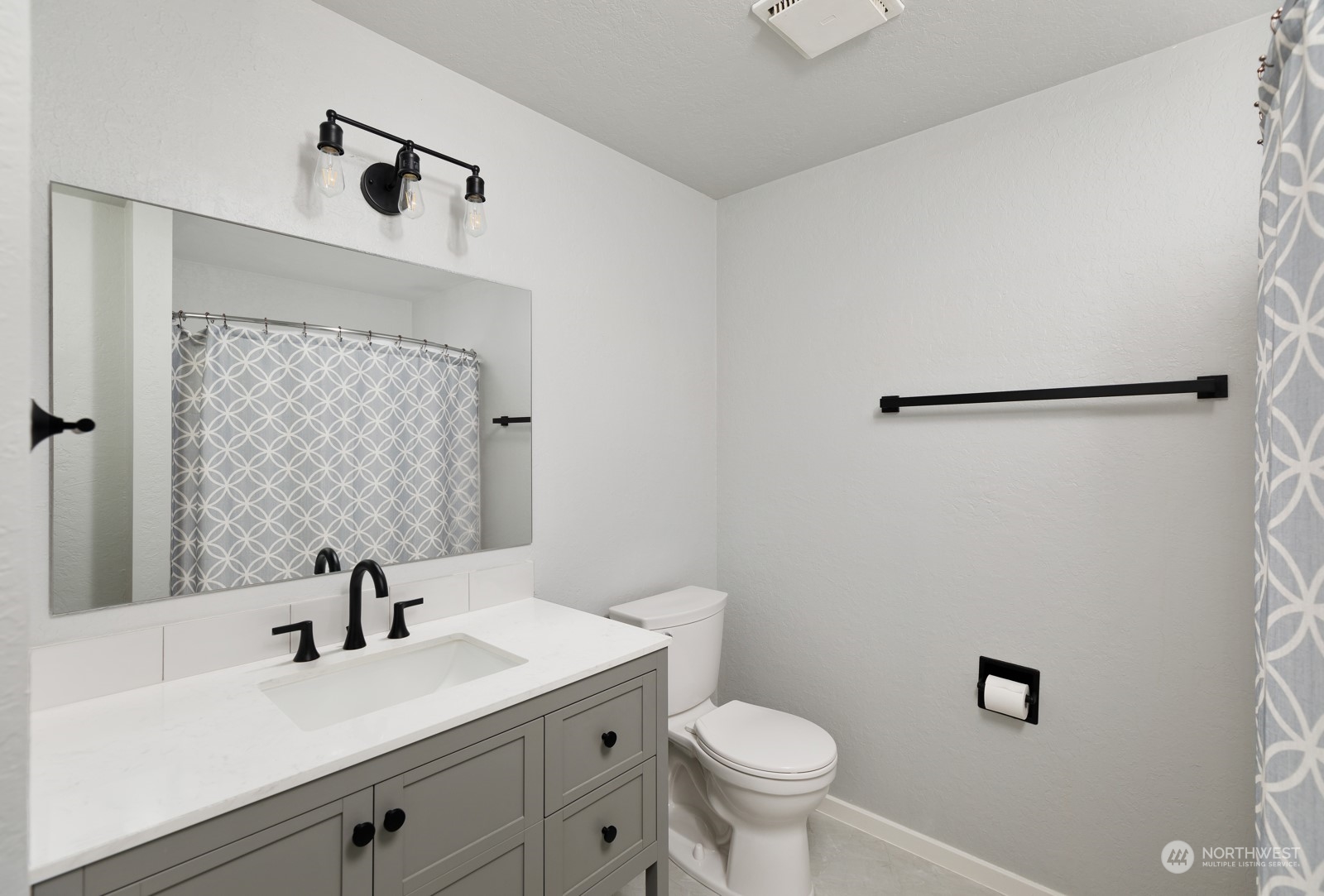 827 Natalie Place Enumclaw, WA 98022 - Photo 10 of 18 a bathroom with a sink mirror vanity and toilet