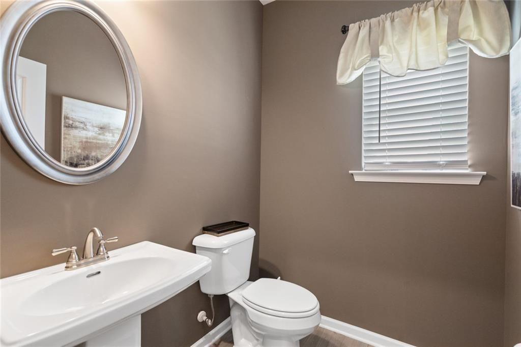 701 Sinclair Lane Temple, GA 30179 - Photo 8 of 46 a bathroom with a toilet a sink and a mirror