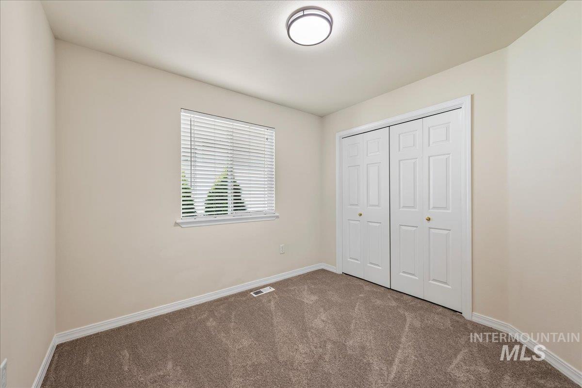 2356 West Hill Road Boise, ID 83702 - Photo 16 of 22 Neutral-toned walls complement the textured carpet flooring