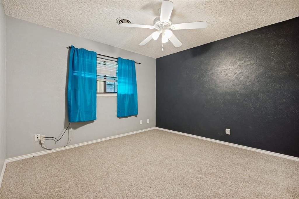 508 South Pedigo Street Pilot Point, TX 76258 - Photo 16 of 26 Carpeted bedroom featuring a ceiling fan with light fixture, textured ceiling, and a window with blinds