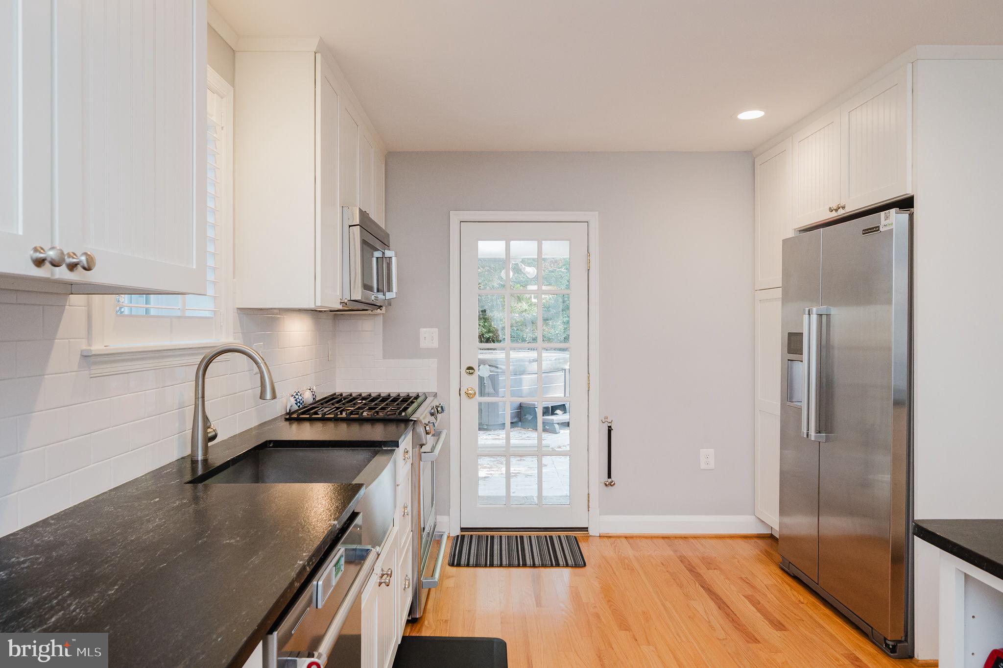 625 Yarmouth Road Towson, MD 21286 - Photo 15 of 69 a kitchen with granite countertop a stove a sink and a refrigerator