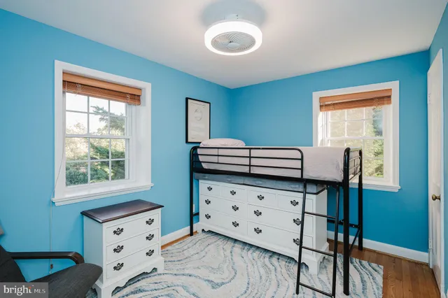 a bathroom with a granite countertop sink and a window
