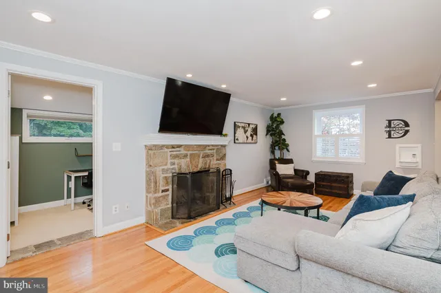 a living room with furniture fireplace and flat screen tv