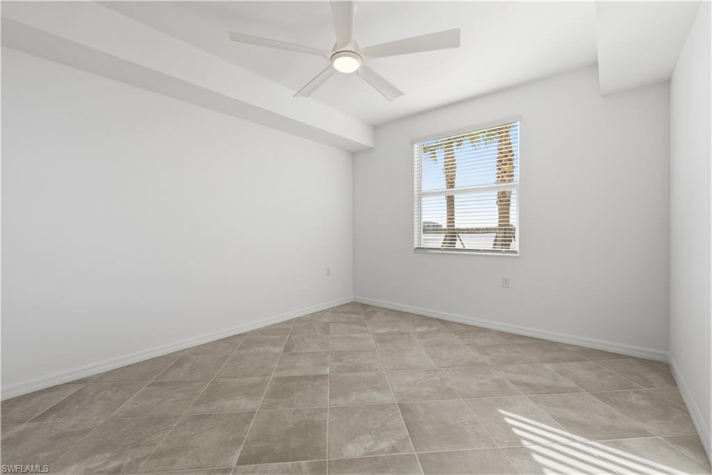 5555 Double Eagle Circle, Unit 3915 Ave Maria, FL 34142 - Photo 20 of 33 an empty room with windows and ceiling fan
