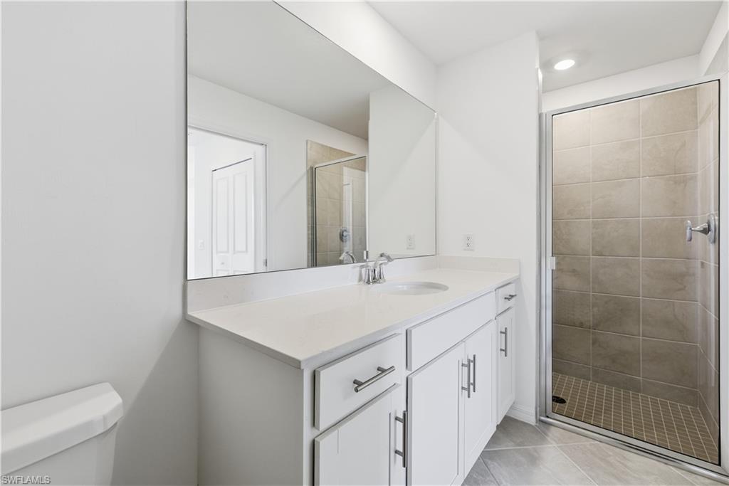 5555 Double Eagle Circle, Unit 3915 Ave Maria, FL 34142 - Photo 23 of 33 a bathroom with a sink a toilet and shower