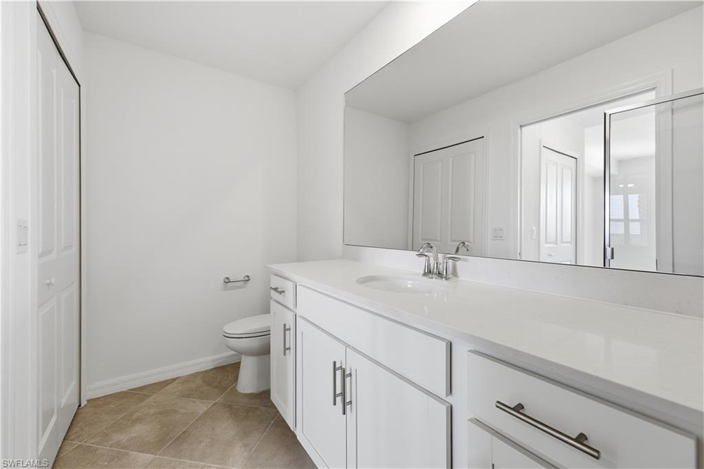 5555 Double Eagle Circle, Unit 3915 Ave Maria, FL 34142 - Photo 24 of 33 a bathroom with a sink and a toilet
